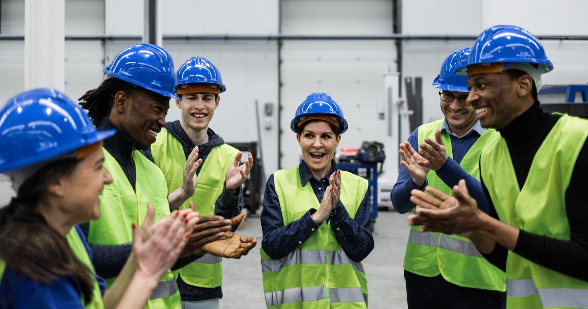 warehouse employees clapping for coworker in gratitude