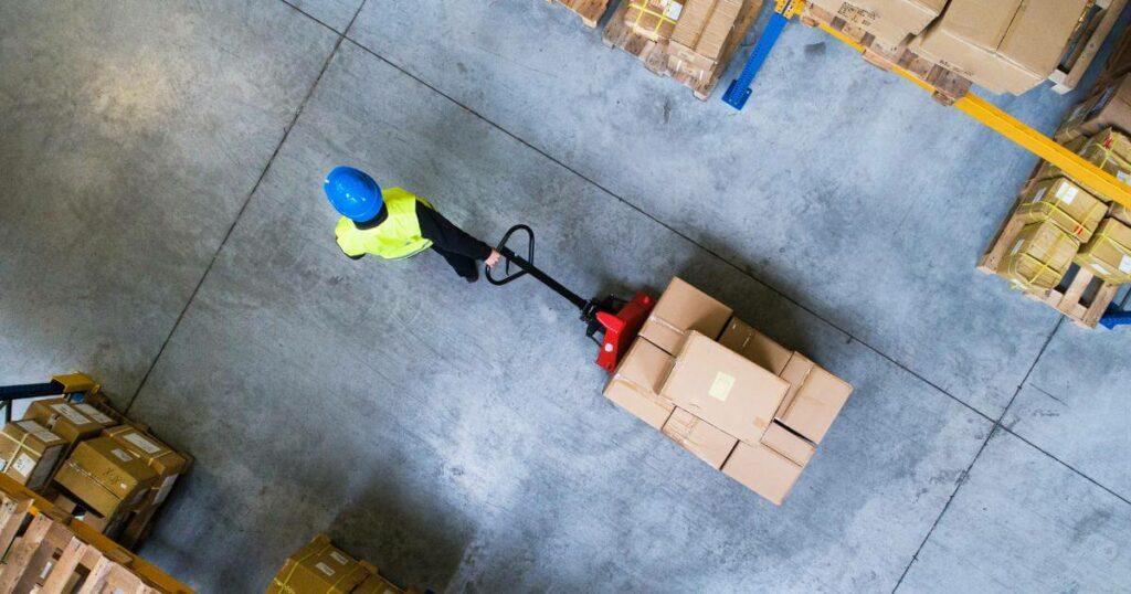 overhead view of warehouse worker pulling pallet jack
