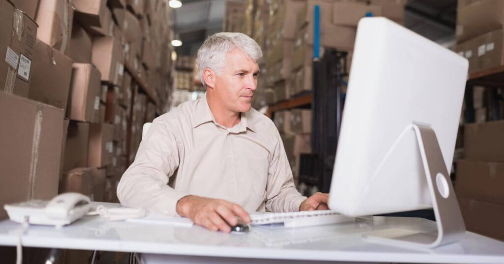 warehouse manager looking at computer monitor