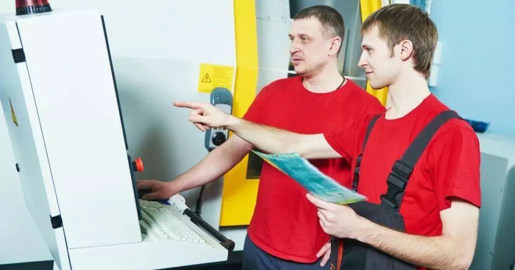 two machine operators troubleshooting