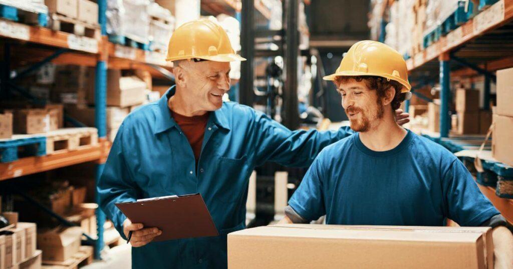 warehouse worker patting coworker on the back