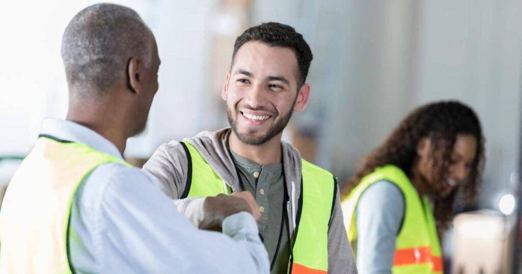 warehouse workers fist bumping