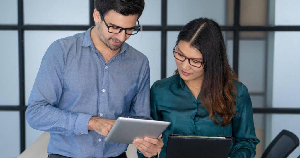 manager and staffing partner looking at tablets