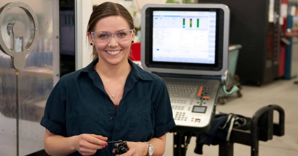 millennial female manufacturing worker in front of computer