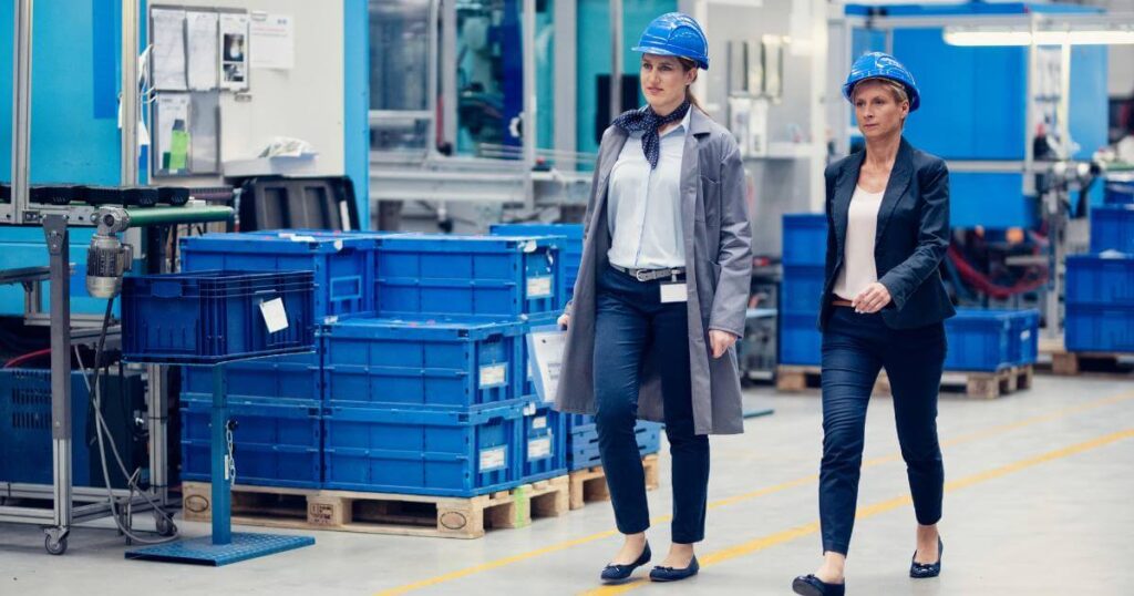 newer and older generation female workers walking manufacturing floor