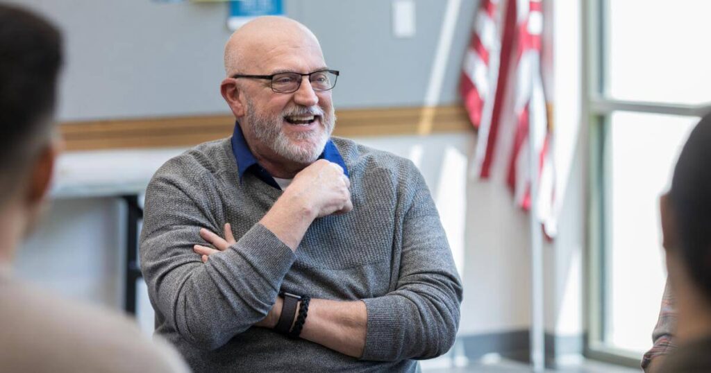 veteran manager laughing during team meeting