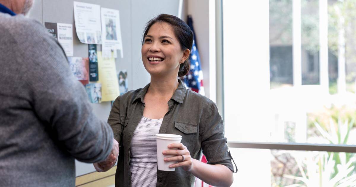 female veteran shaking hands with coworker