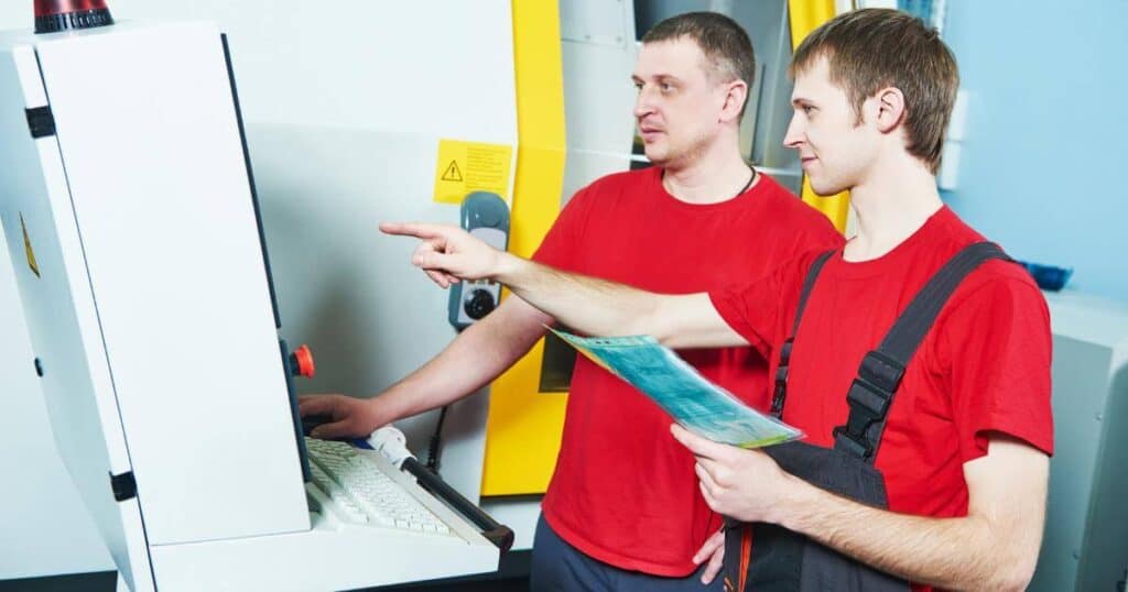 two machine operators troubleshooting