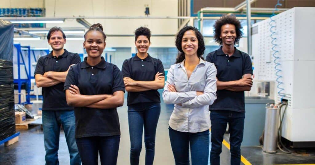 group of warehouse workers smiling at camera