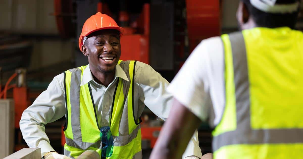 laughing employee talking to coworker in positive work environment
