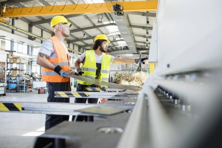 Male manual workers manufacturing sheet metal