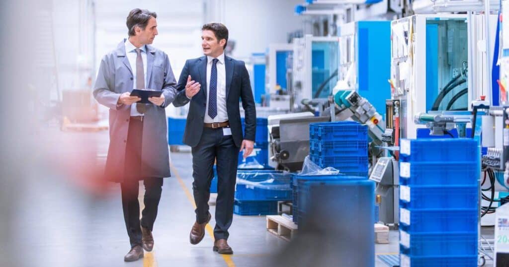 hiring manager walking production floor with staffing partner